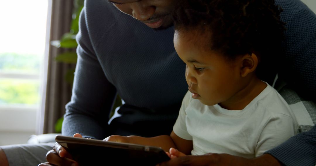 Father and Child Bonding While Using Tablet at Home - Free Images, Stock Photos and Pictures on Pikwizard.com