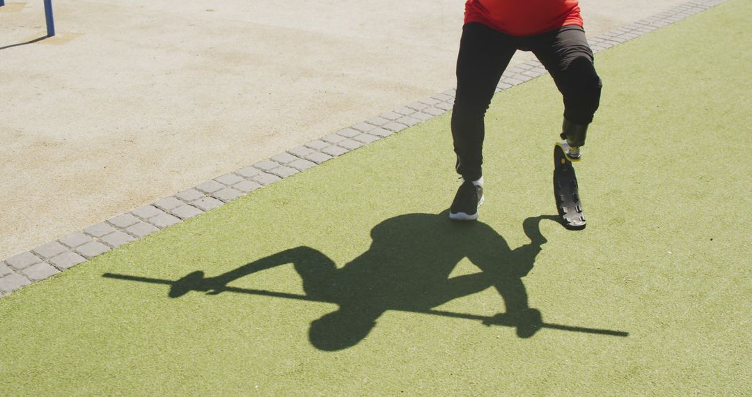 Biracial man exercising and lifting weight bar with prosthetic leg - Free Images, Stock Photos and Pictures on Pikwizard.com