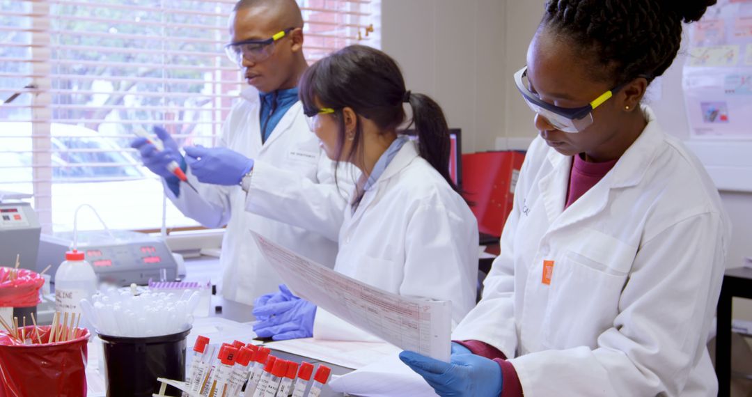 Scientists Working in Laboratory Analyzing Samples with Safety Gear - Free Images, Stock Photos and Pictures on Pikwizard.com