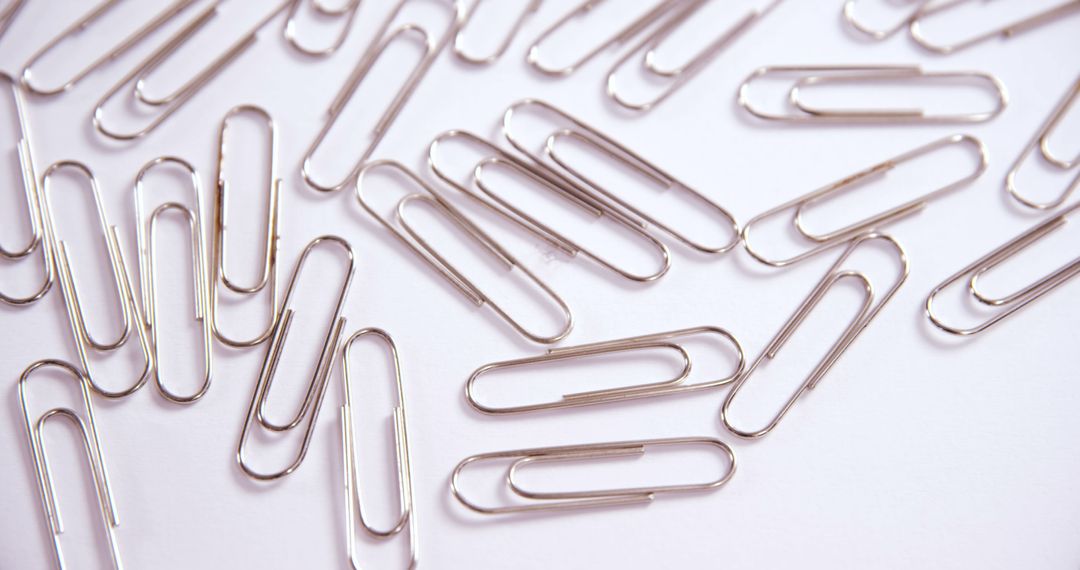 Scattered Paperclips on White Background - Free Images, Stock Photos and Pictures on Pikwizard.com