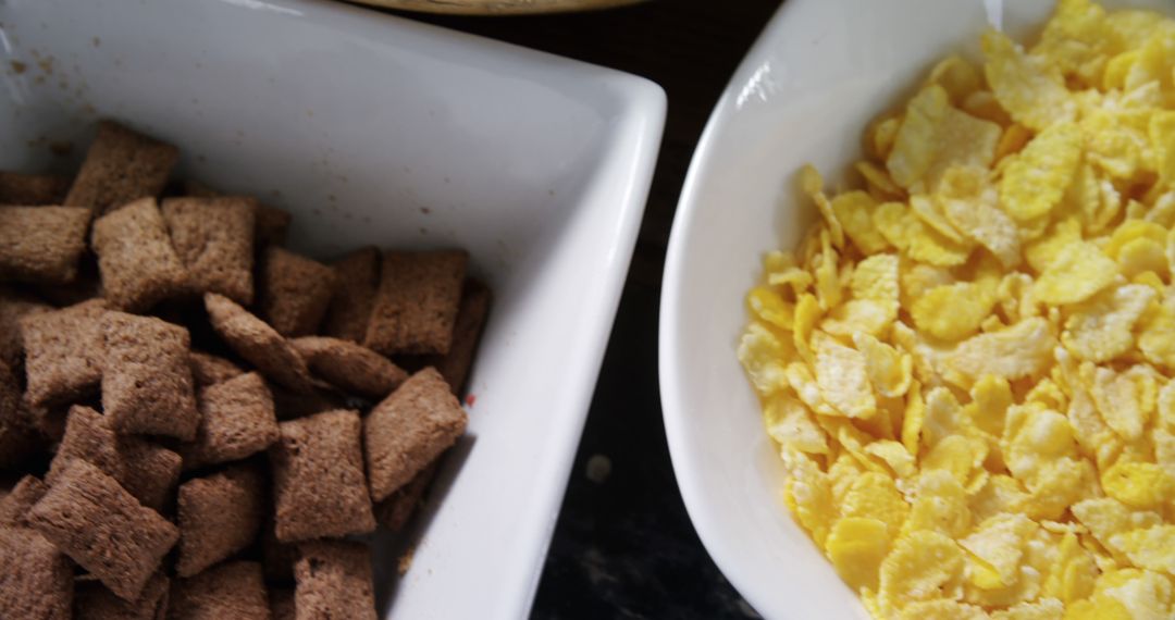 Close-Up of Chocolate and Corn Flakes Cereal in White Bowls - Free Images, Stock Photos and Pictures on Pikwizard.com