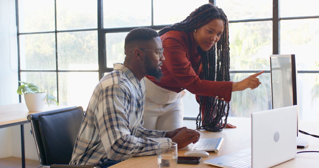 Colleagues Collaborating at Office Desk Analyzing Data
