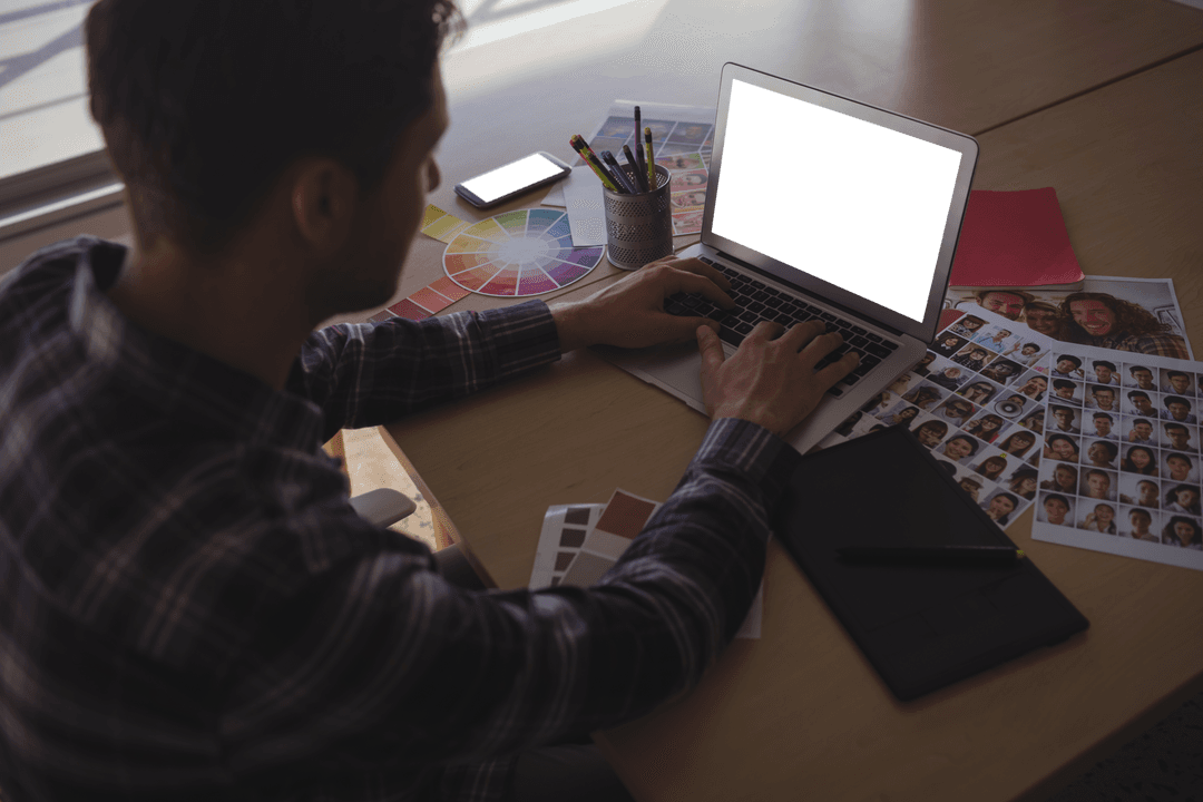 Transparent Male Photo Editor Busy at Work Using Laptop