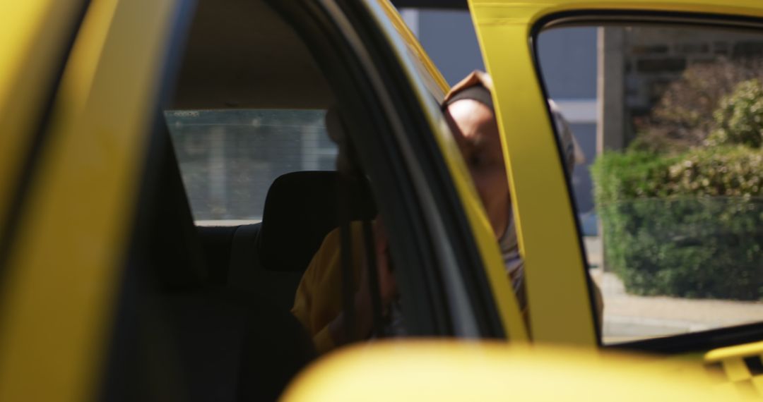 Unrecognizable Person in Yellow Car Capturing Urban Commute Moment - Free Images, Stock Photos and Pictures on Pikwizard.com