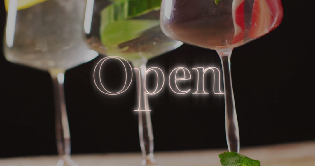 Glowing 'Open' Sign with Colorful Cocktails on Black Background