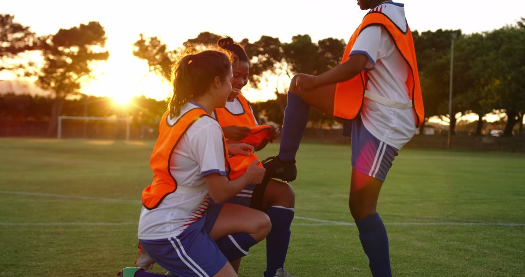 Female Youth Soccer Players Preparing Outdoor at Sunset - Free Images, Stock Photos and Pictures on Pikwizard.com