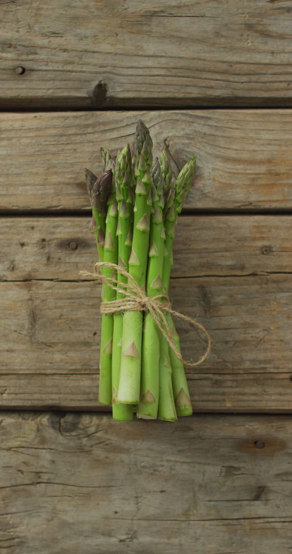 Bunch of Fresh Asparagus on Rustic Wooden Table