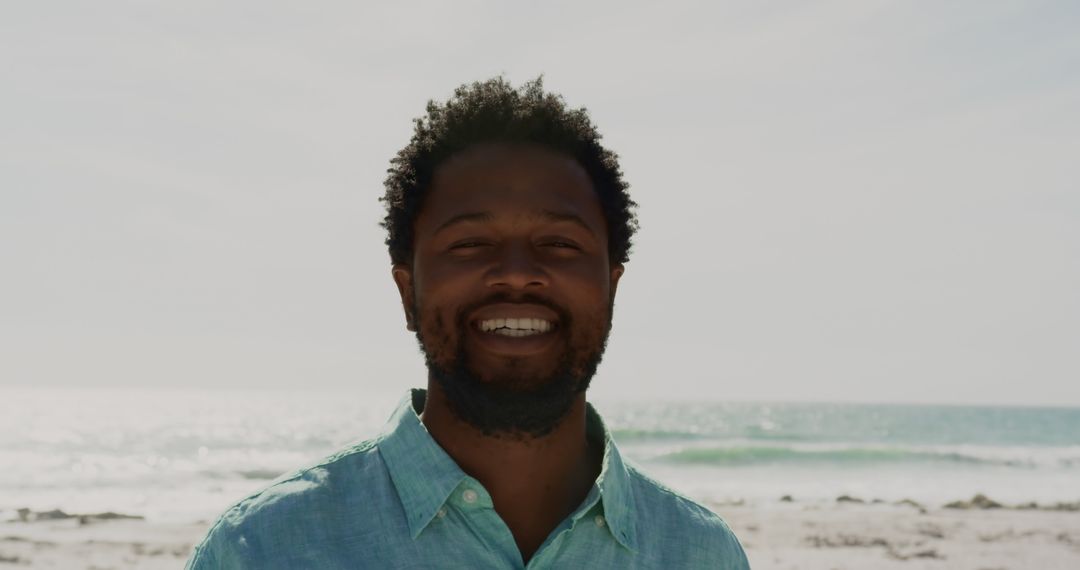 Smiling Young Man Enjoying Sunny Day at Beachfront
