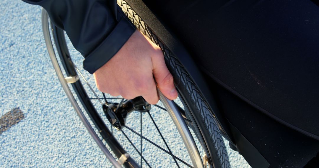 Close-Up of Person's Hand on Wheelchair Rim in Motion - Free Images, Stock Photos and Pictures on Pikwizard.com