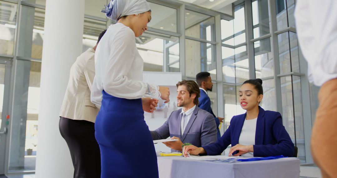 Professionals Registering at Conference Table with Diverse Group