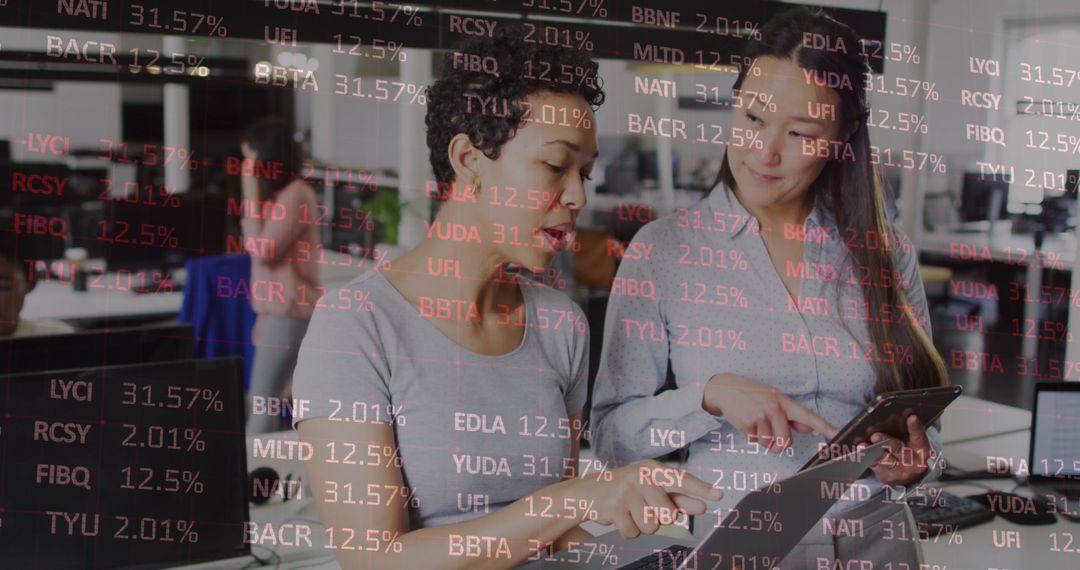 Diverse Female Professionals Collaborating on Financial Data Analysis in Modern Office