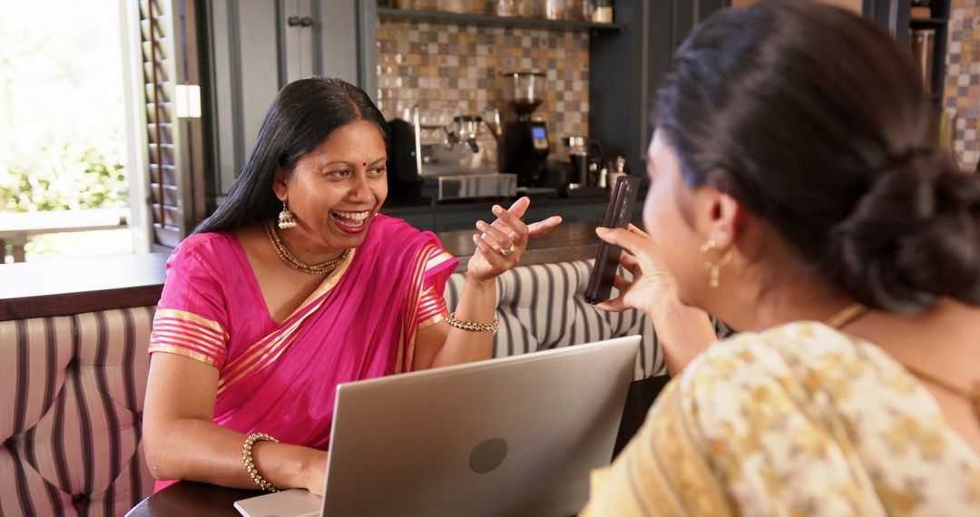 Smiling Indian Woman in Sari Connecting Through Technology