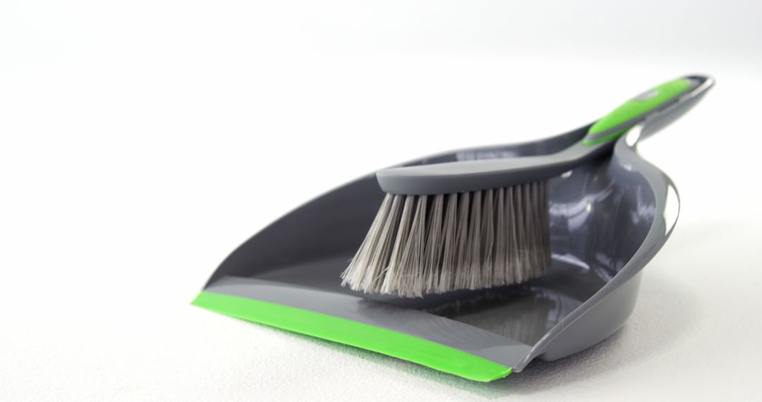 Close-Up of Grey Dustpan and Brush Set on White Background - Free Images, Stock Photos and Pictures on Pikwizard.com