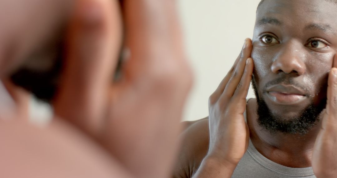 Man Inspecting Face in Mirror for Perfect Skincare Routine