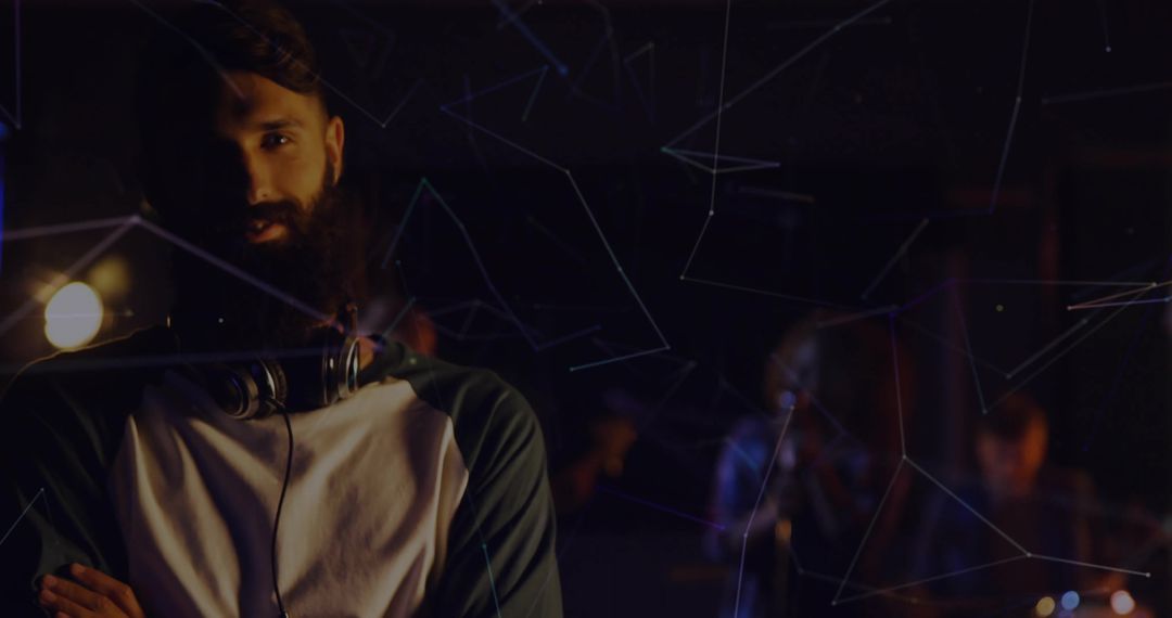 Bearded Musician With Headphones in Tech-Inspired Studio