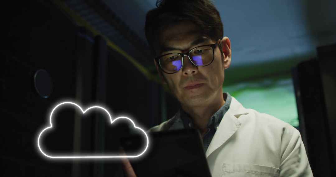 Asian Technician Analyzing Data with Cloud Icon in Server Room