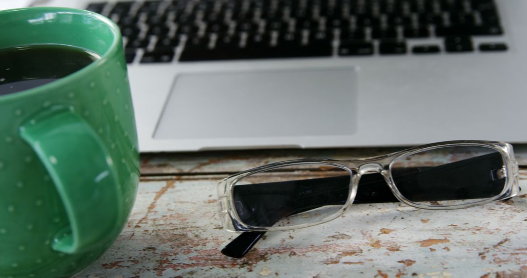 Close-up of Coffee, Eyeglasses, and Laptop on Rustic Wooden Table - Free Images, Stock Photos and Pictures on Pikwizard.com