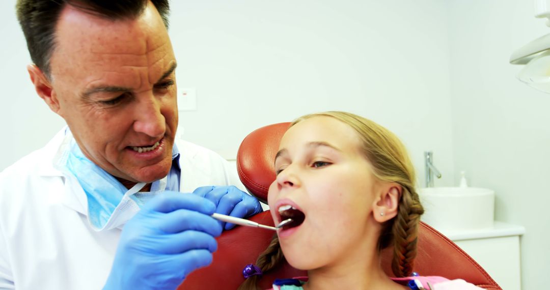 Dentist Examining Young Girl's Teeth During Check-Up - Free Images, Stock Photos and Pictures on Pikwizard.com