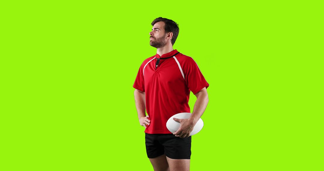 Rugby Player Holding Ball in Red Jersey Isolated on Green Background - Free Images, Stock Photos and Pictures on Pikwizard.com