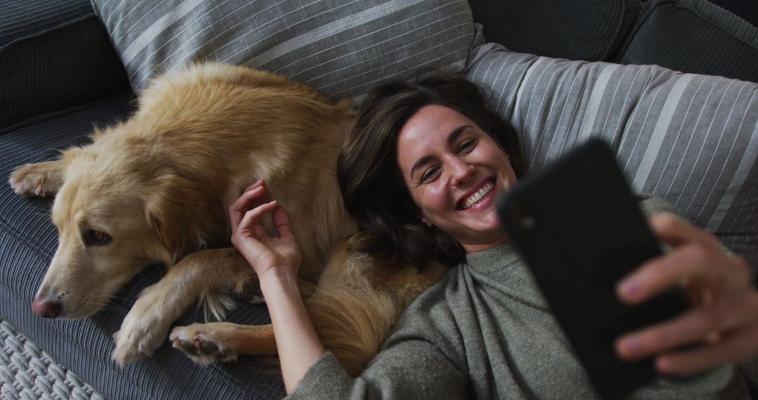 Happy Woman Taking Selfie with Dog on Sofa at Home