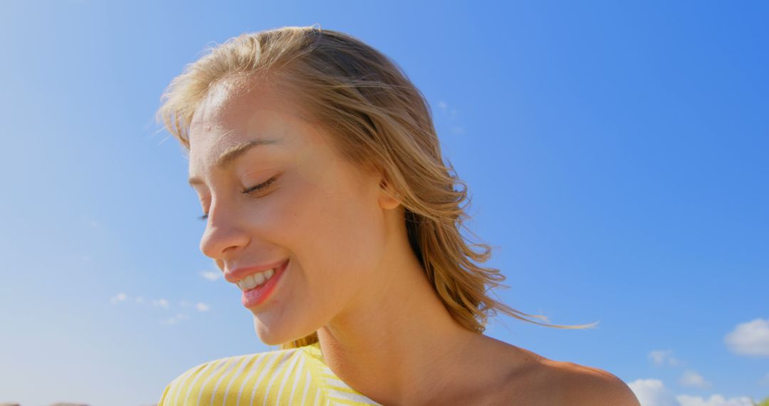 Young Woman Smiling in Bright Sunlight at Beach - Free Images, Stock Photos and Pictures on Pikwizard.com