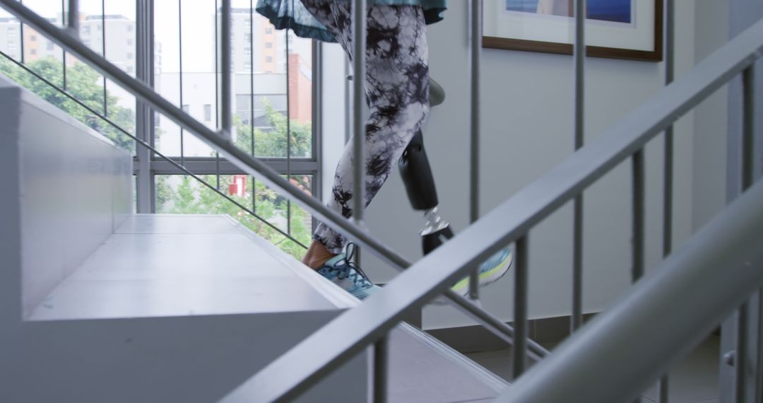 Person with prosthetic leg ascending stairs in gym - Free Images, Stock Photos and Pictures on Pikwizard.com