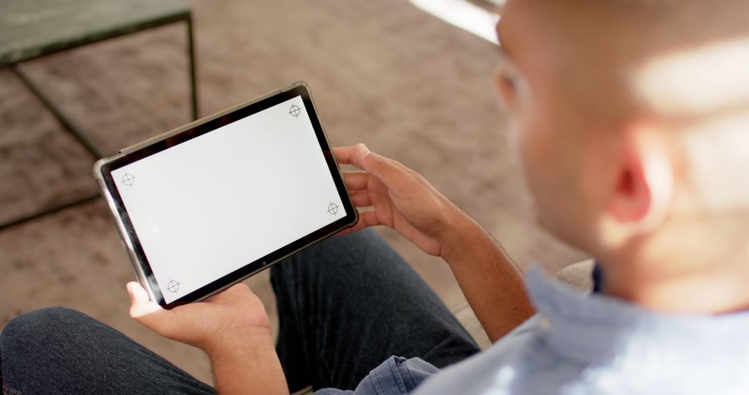 Man Holding Tablet at Home with Blank Screen for Creative Projects - Free Images, Stock Photos and Pictures on Pikwizard.com