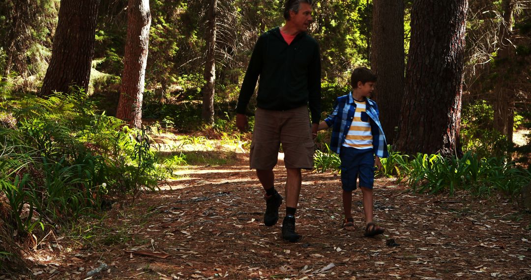 Father and Son Walking in Forest Trail for Outdoor Adventure - Free Images, Stock Photos and Pictures on Pikwizard.com