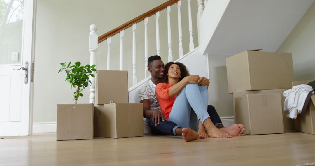 Happy Couple Embracing Amid Moving Boxes in New Home - Free Images, Stock Photos and Pictures on Pikwizard.com