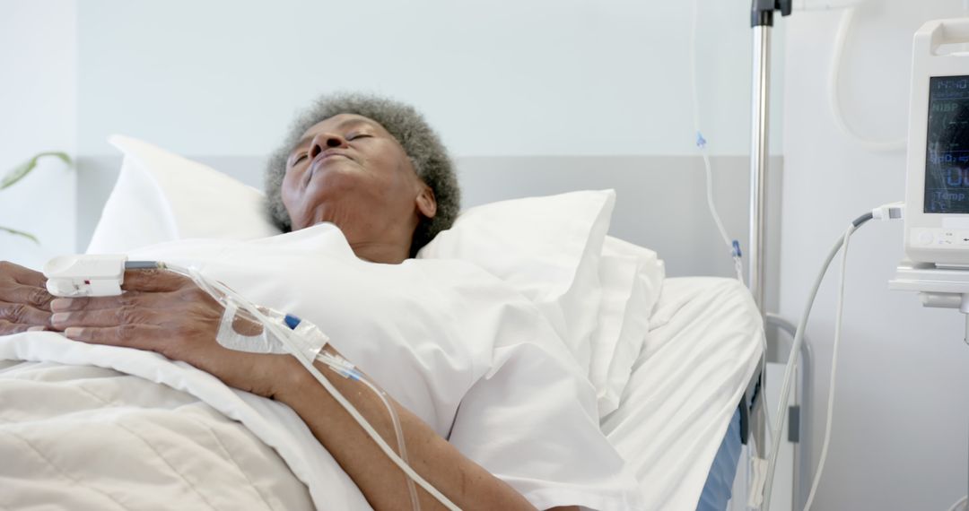 Senior Patient Lying in Hospital Bed Receiving Medical Care - Free Images, Stock Photos and Pictures on Pikwizard.com