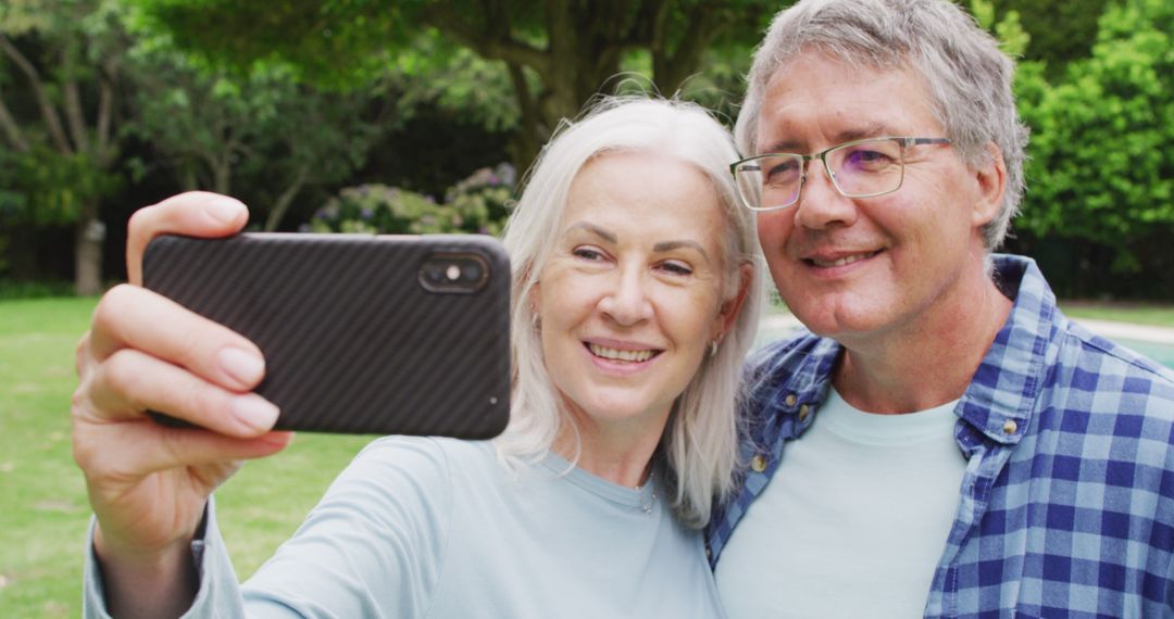 Image of caucasian senior couple embracing in garden, taking selfie - Free Images, Stock Photos and Pictures on Pikwizard.com