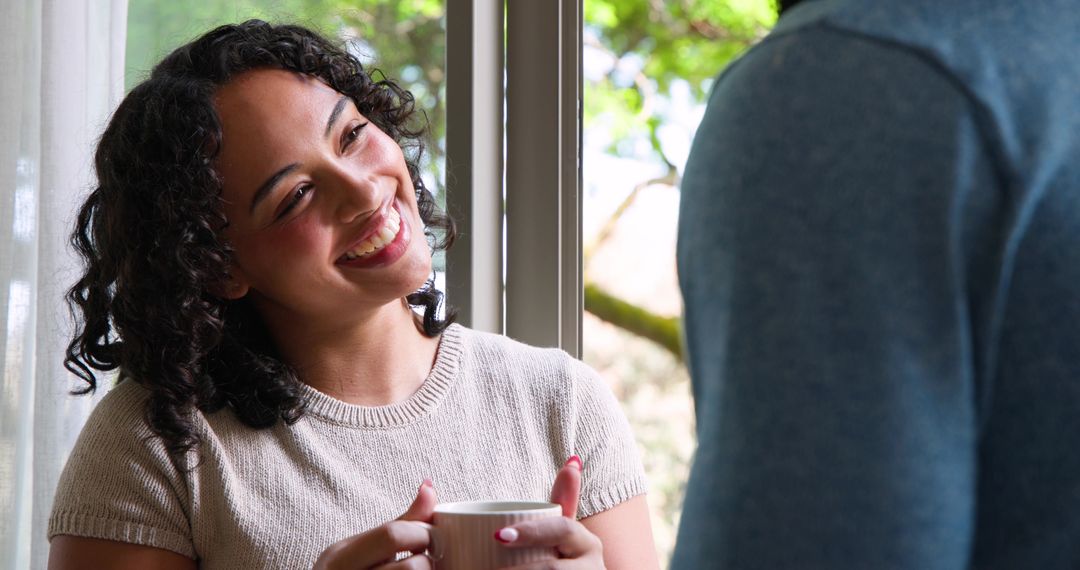 Smiling Couple Enjoying Relaxing Moment at Home Near Window