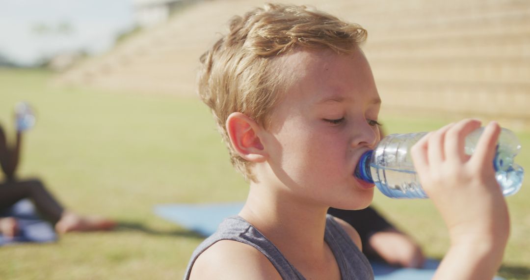 Young Boy Drinking Water During Outdoor Sports Activity - Free Images, Stock Photos and Pictures on Pikwizard.com