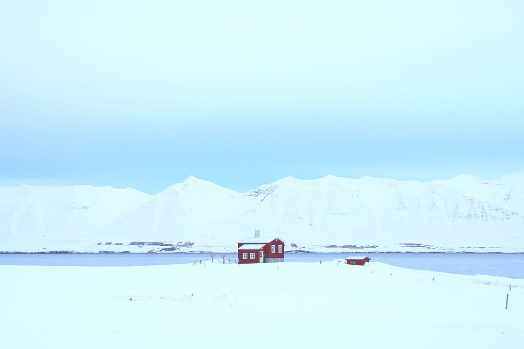 Solitary Red Cabin in Pristine Snowy Landscape