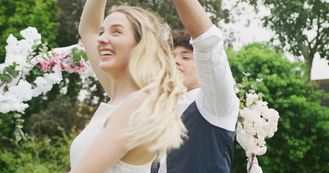 Joyful Couple Dancing in Garden Wedding Celebration