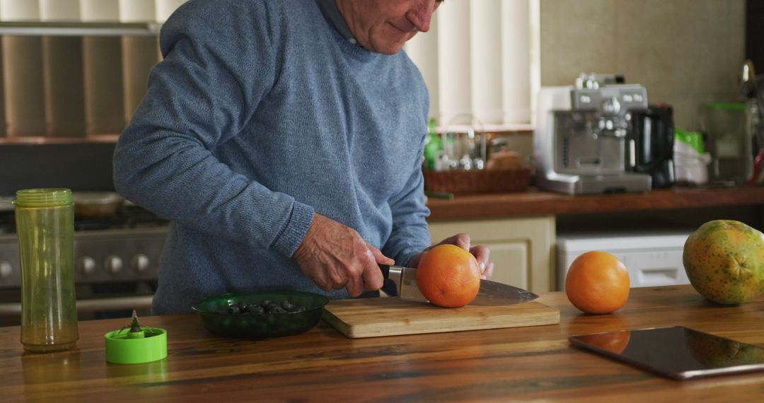 Senior Man Making Fresh Juice at Home Kitchen Using Grapefruit - Free Images, Stock Photos and Pictures on Pikwizard.com