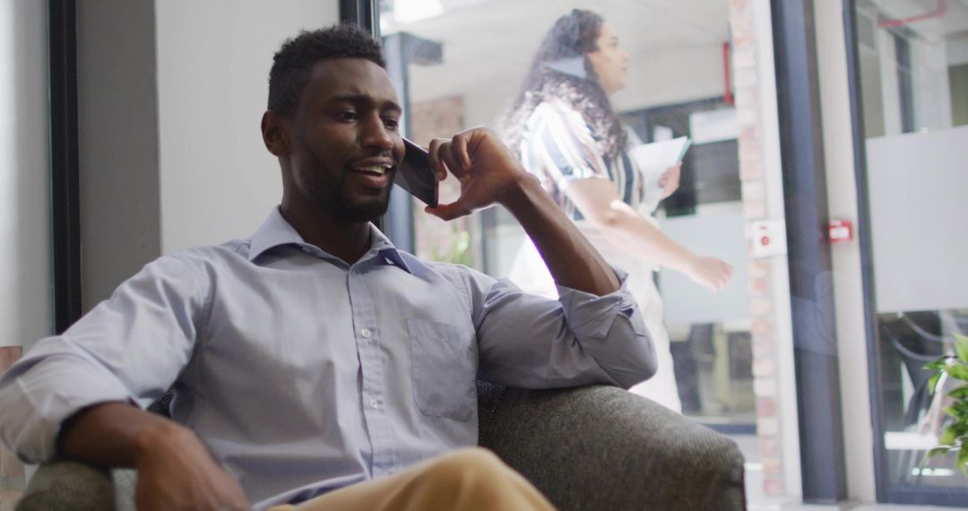 Confident Professional Talking on Smartphone in Modern Workspace