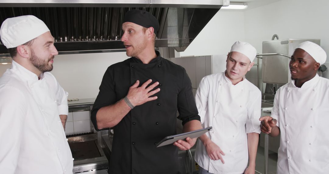 Chef Instructing Diverse Trainee Cooks with Tablet in Restaurant Kitchen - Free Images, Stock Photos and Pictures on Pikwizard.com