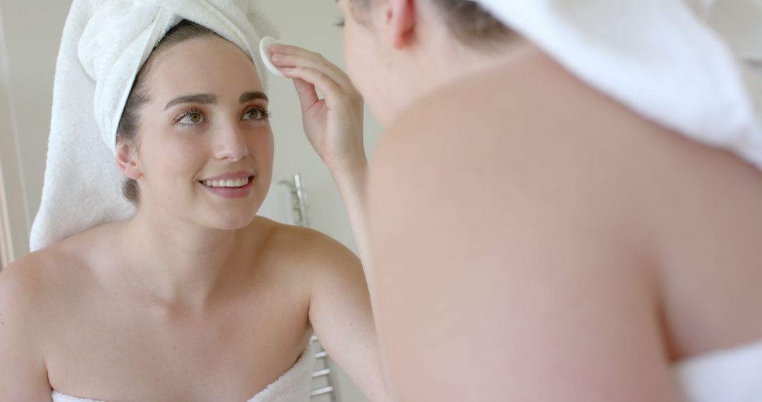 Woman Smiling While Applying Skincare Routine in Bathroom - Free Images, Stock Photos and Pictures on Pikwizard.com