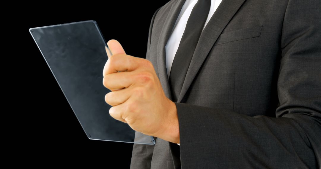 Businessman Holding Transparent Tablet Screen on Black Background