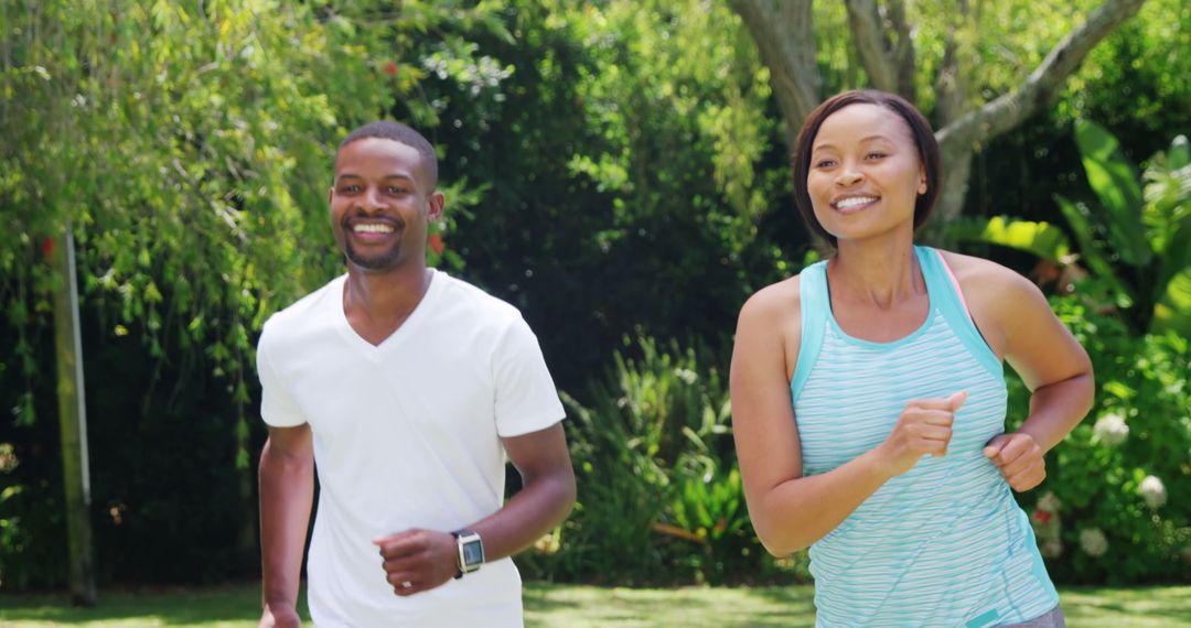 Happy Couple Enjoying a Run in Lush Green Park