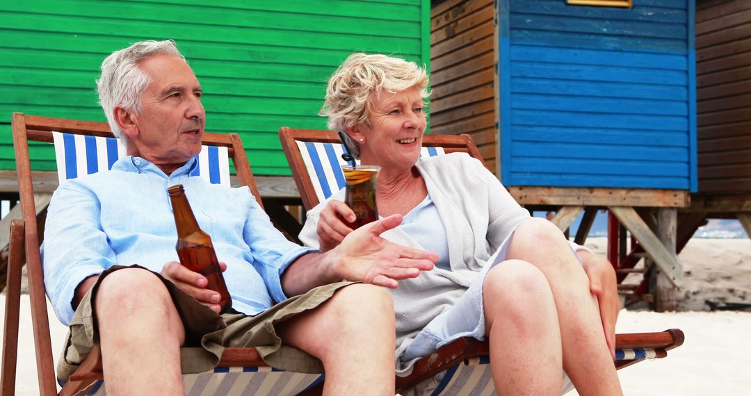 Senior Couple Relaxing on Beach with Beverages - Free Images, Stock Photos and Pictures on Pikwizard.com