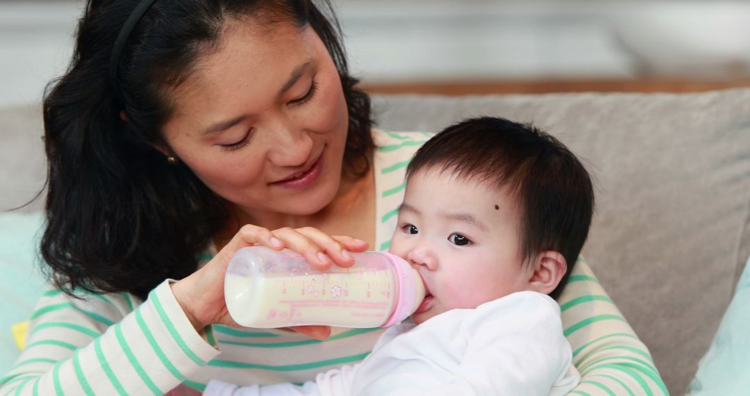 Mother Feeding Baby with Bottle at Home - Free Images, Stock Photos and Pictures on Pikwizard.com