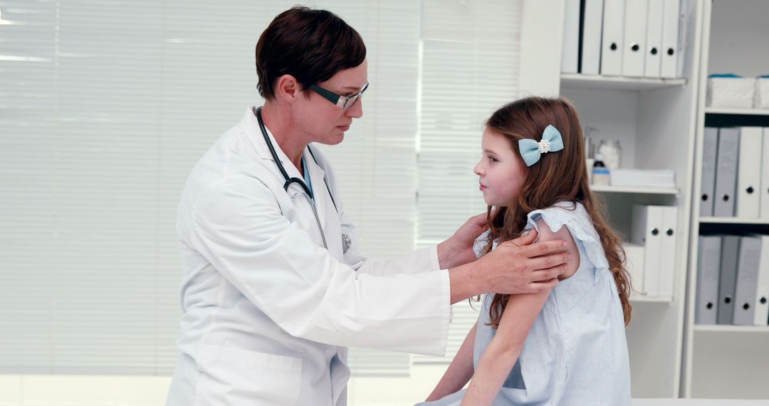 Doctor Examining Young Female Patient in Medical Office - Free Images, Stock Photos and Pictures on Pikwizard.com