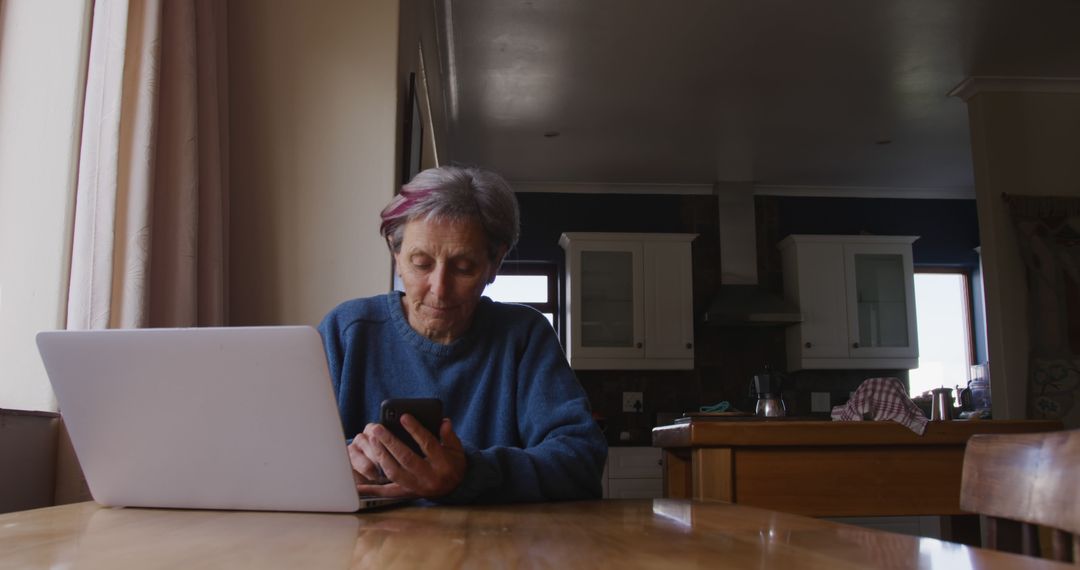 Senior Woman Using Laptop and Smartphone at Home - Free Images, Stock Photos and Pictures on Pikwizard.com