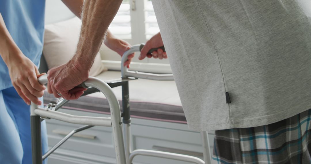 Male Patient Using Walker with Nurse Assistance in Rehabilitation Center - Free Images, Stock Photos and Pictures on Pikwizard.com