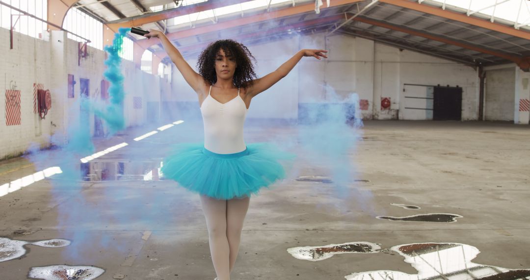 Ballet dancer performing with smoke bomb in industrial warehouse - Free Images, Stock Photos and Pictures on Pikwizard.com