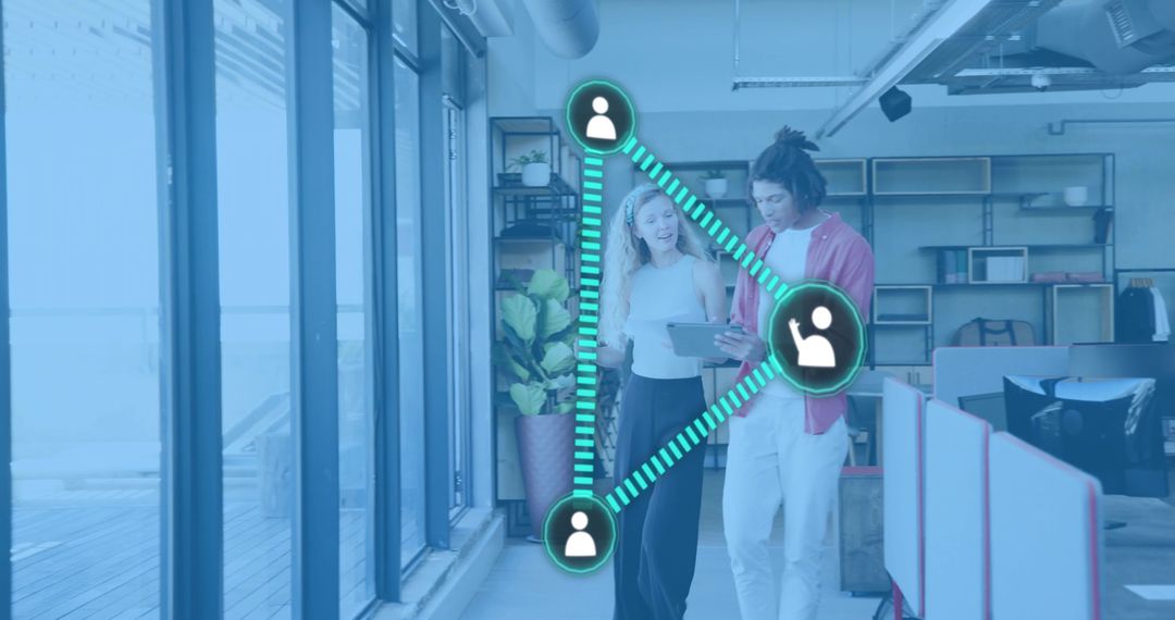 Two professionals walking and viewing tablet with digital network overlay in modern office