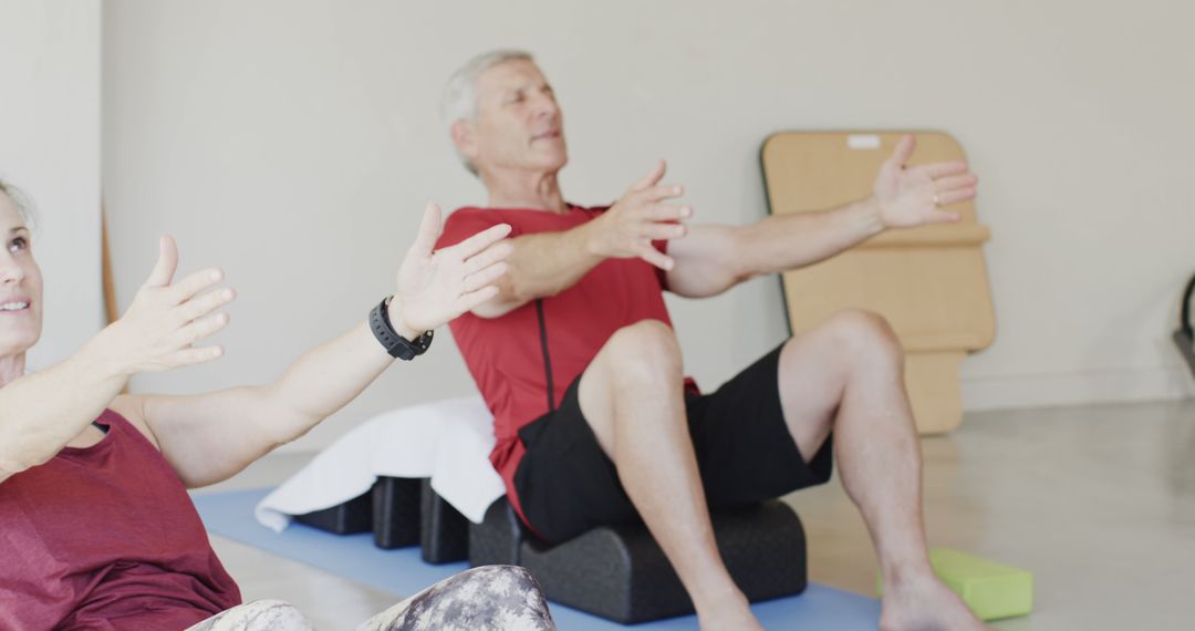 Two Elderly Individuals Exercising in Yoga Class - Free Images, Stock Photos and Pictures on Pikwizard.com