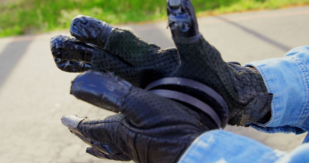 Close-up of Person Wearing Black Motorcycle Gloves Showing Peace Sign - Free Images, Stock Photos and Pictures on Pikwizard.com